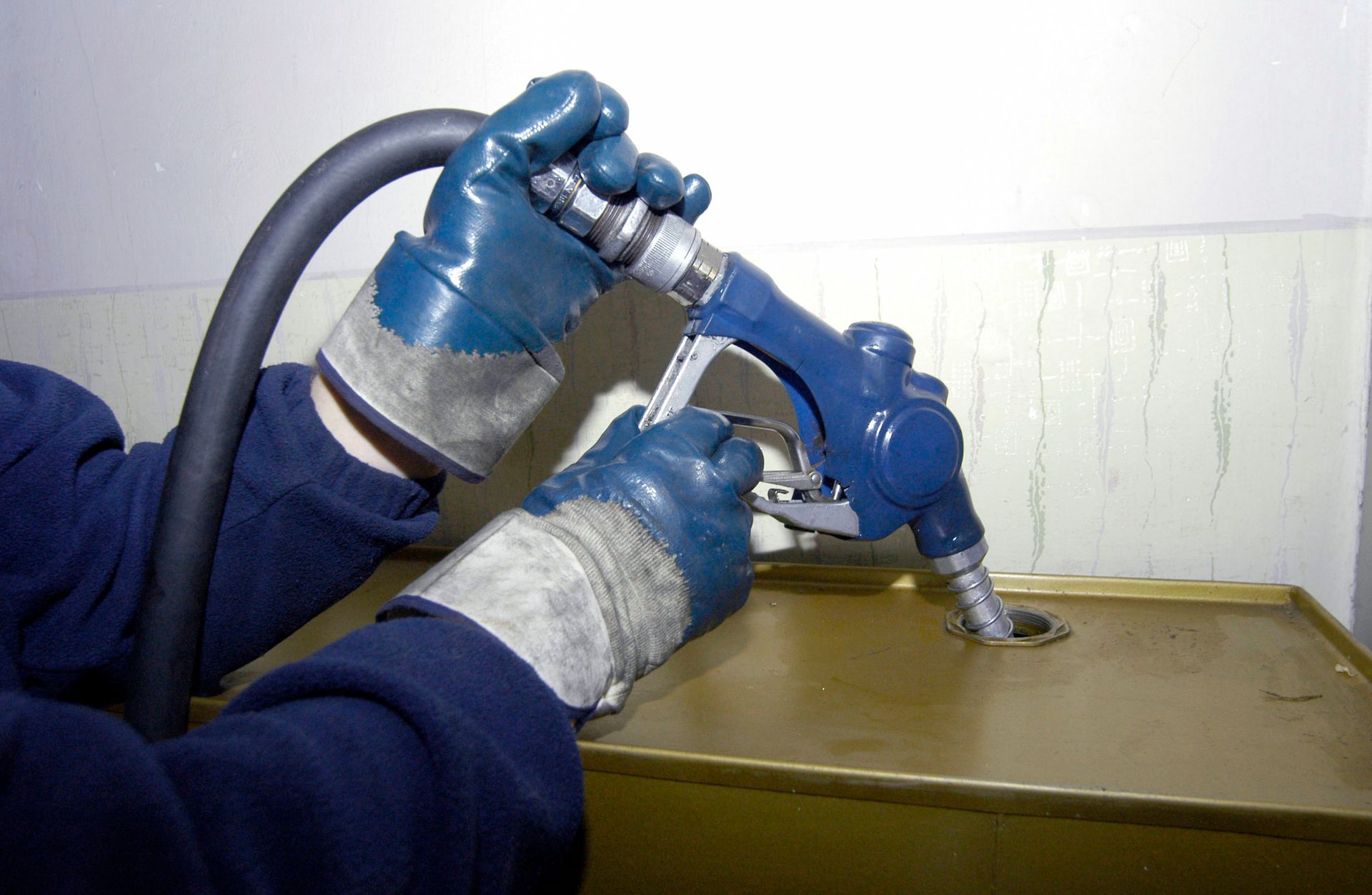 A Person in Blue Gloves Fills a Heating Oil Tank at Edris Oil Service in York, Pa.