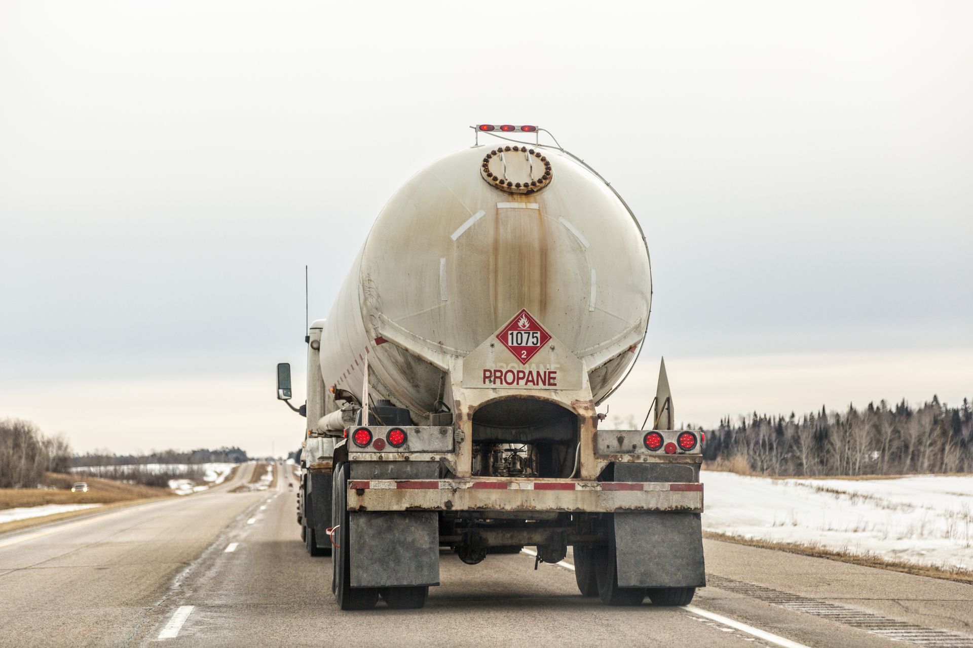 The propane truck moves down the highway, ensuring timely service and a dependable supply. The propane truck moves down the highway, ensuring timely service and a dependable supply.