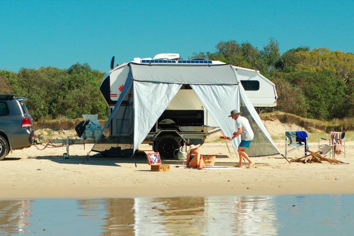 Adventure-Ready Camper on the beach with awning — Ozzie Camper Trailers in Aitkenvale, QLD