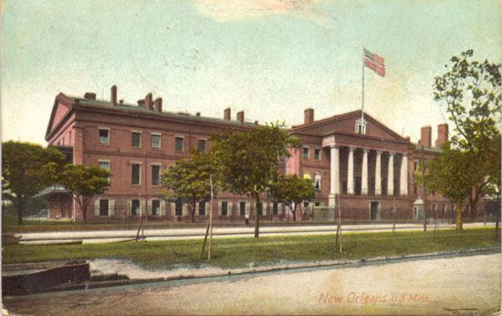 A large brick building with a flag on top of it