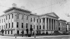 A black and white photo of a large building with columns.