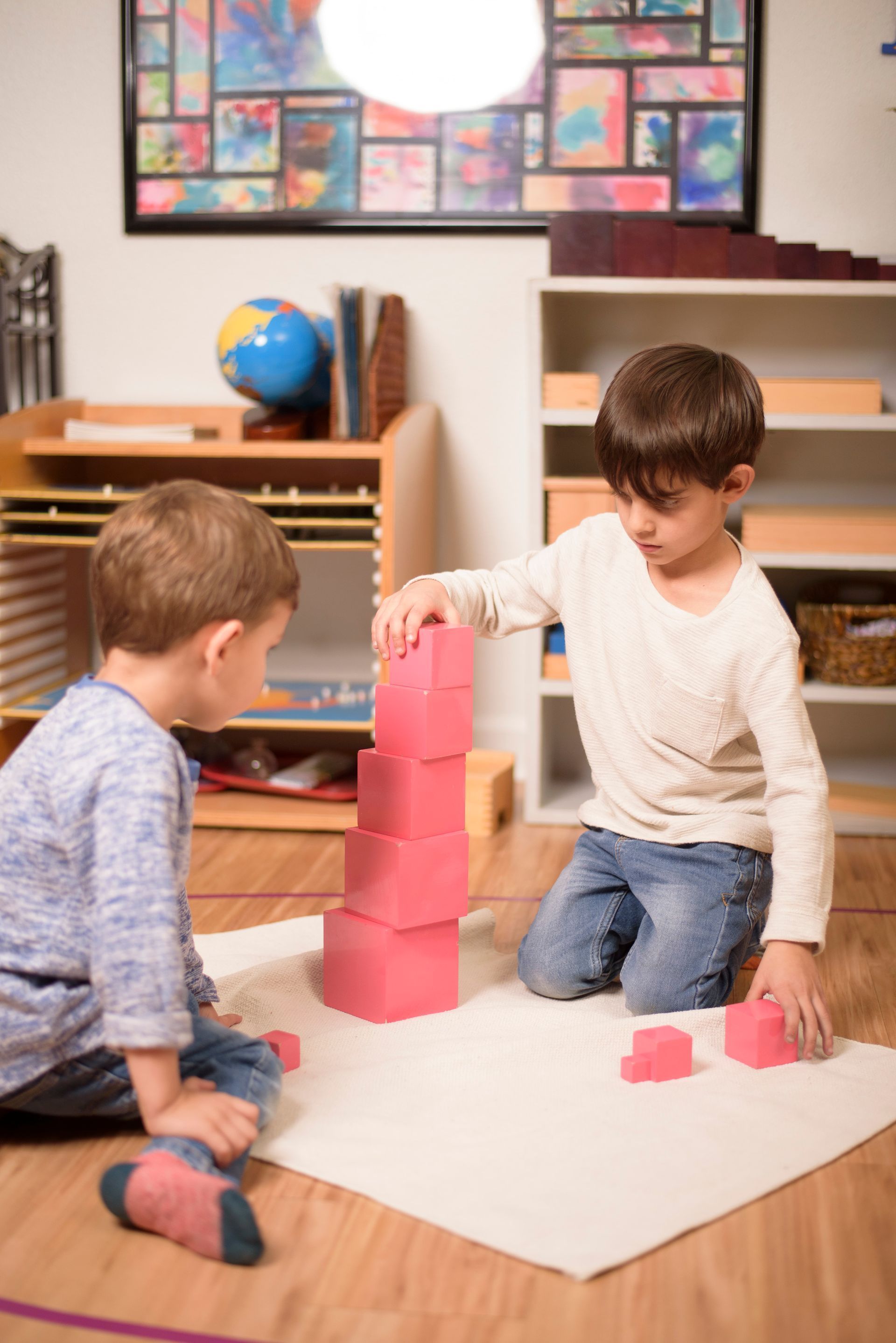 Montessori infant pushing a cart