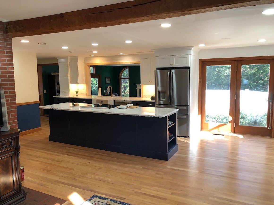 A kitchen with a large island and stainless steel appliances.