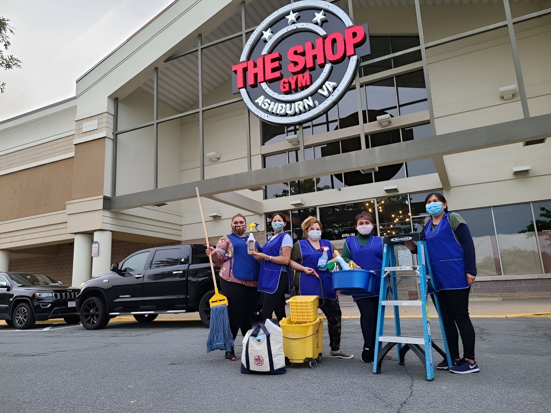 People in blue cleaning uniforms stand in front of