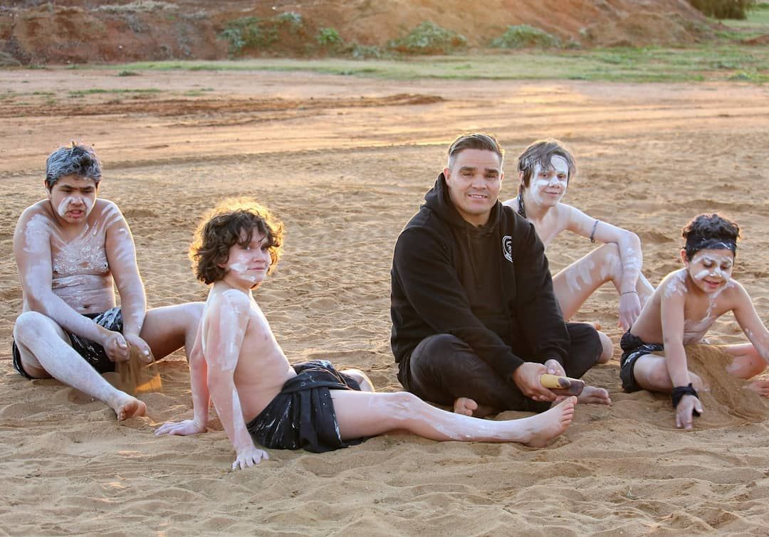 Man Holding Clap Sticks — Dinawan's Connection in Dubbo, NSW