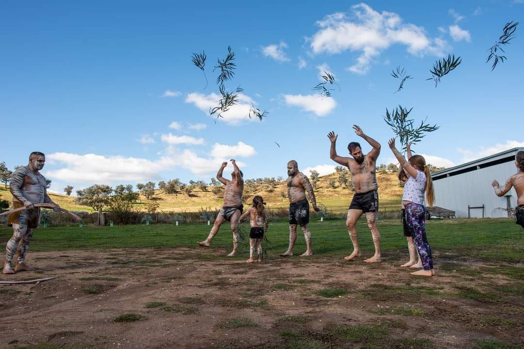 Elderly Aboriginal Instructing Young Children in Traditional Dance — Dinawan's Connection in Dubbo, NSW