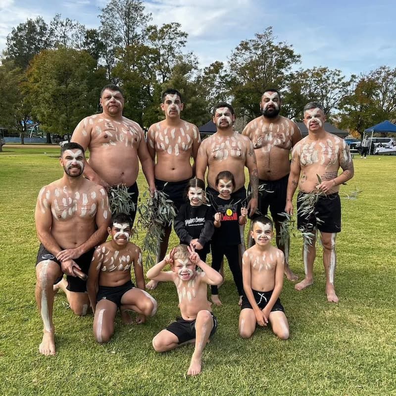 Aboriginal Community with Body Paint Holding Leaves in Hand — Dinawan's Connection in Dubbo, NSW