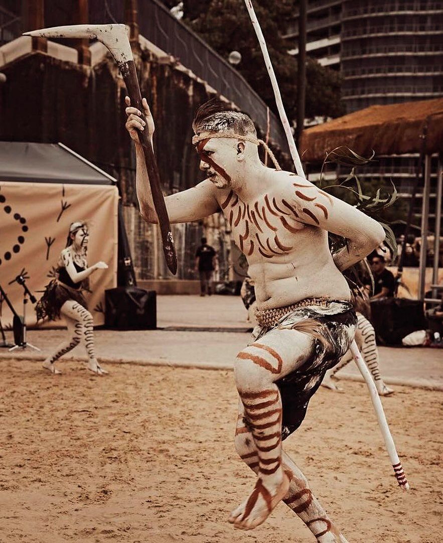 Man in Tribal Body Paint Dances, Holding a Staff, Outdoors. Another Dancer in Background — Dinawans Connection in Cowra, NSW