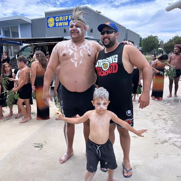 An Adult With White Body Paint Stands With a Man and a Boy With White Face Paint — Dinawans Connection in Mudgee, NSW