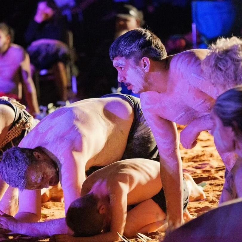 People Covered in White Substance Crawl on the Ground Performing Traditional Dance — Dinawans Connection in Orange, NSW