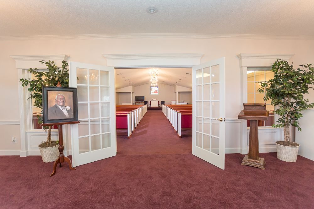 There is a picture of a man on a stand in the middle of the church.