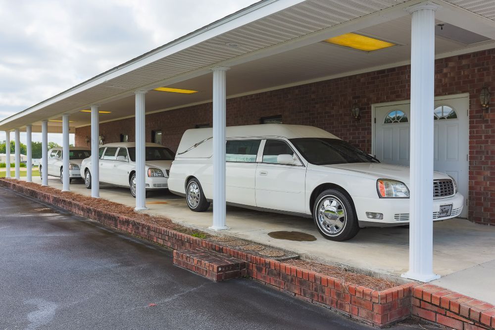 A living room with a couch , chairs , and a chandelier.