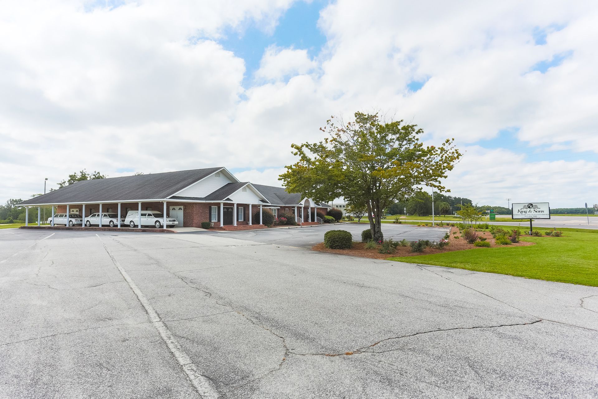 A building with a lot of cars parked in front of it