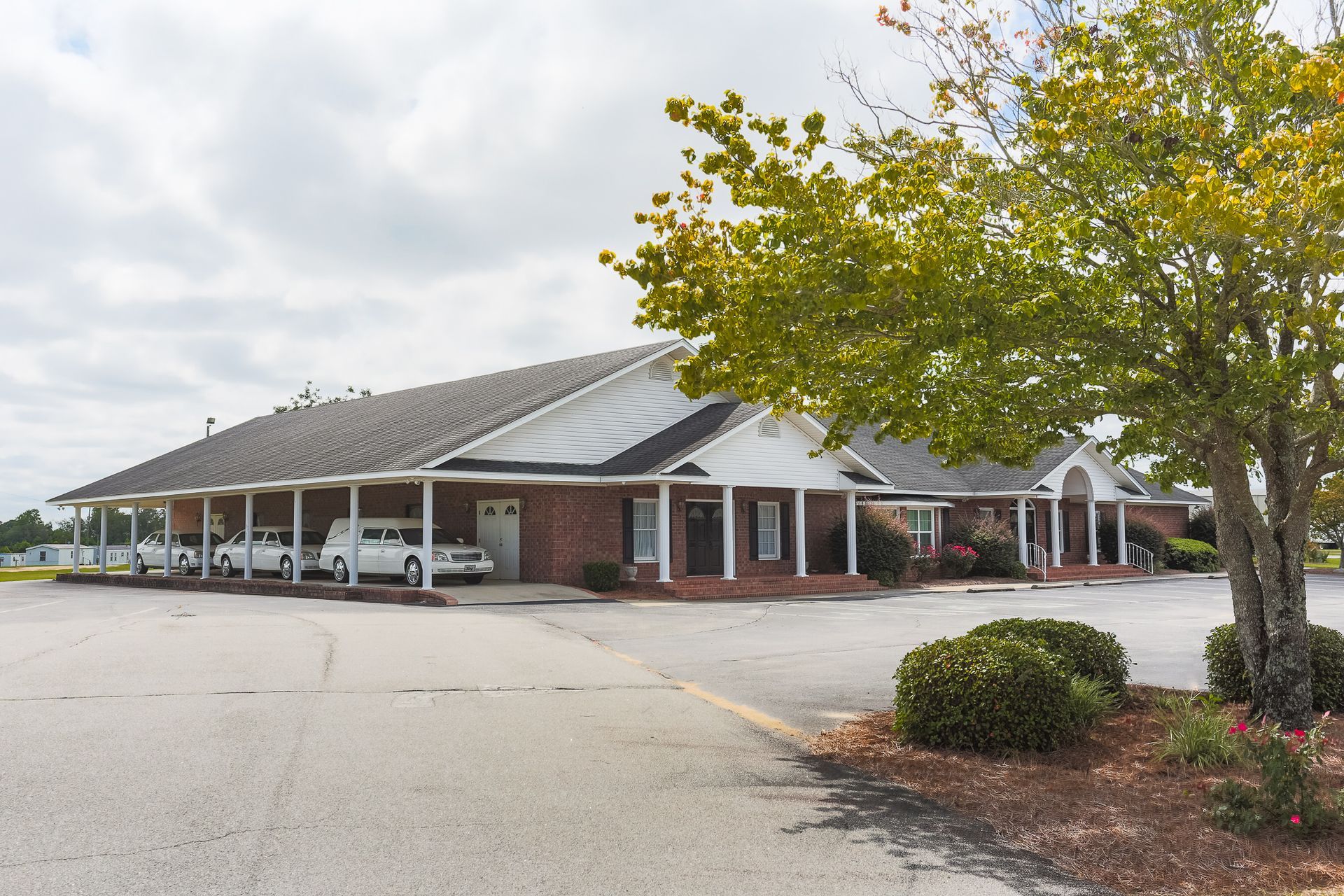 A large brick building with a sign in front of it.