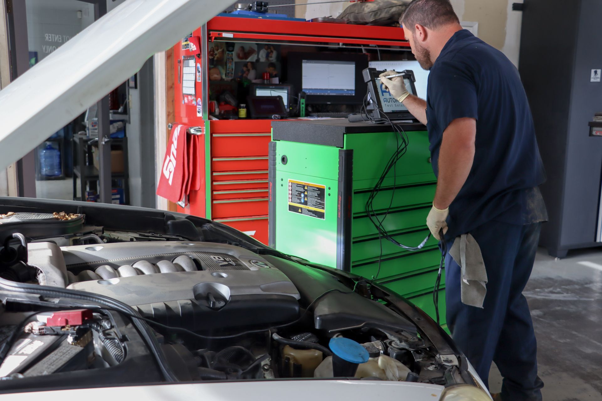 Bowman using diagnostic tool to inspect vehicle