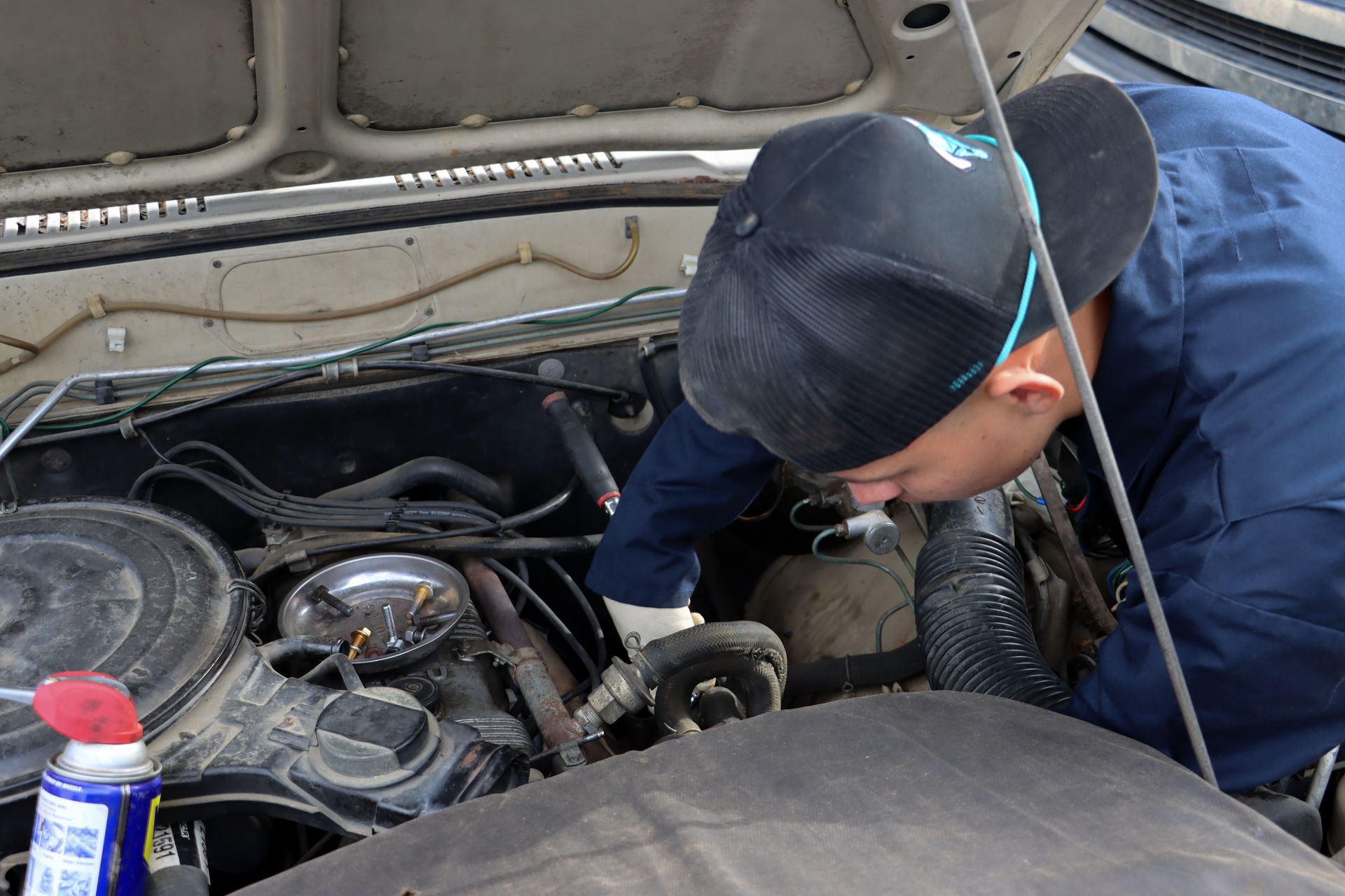 Moy inspecting hood of vehicle
