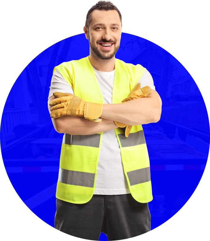 Man in safety vest and gloves with arms crossed, smiling.