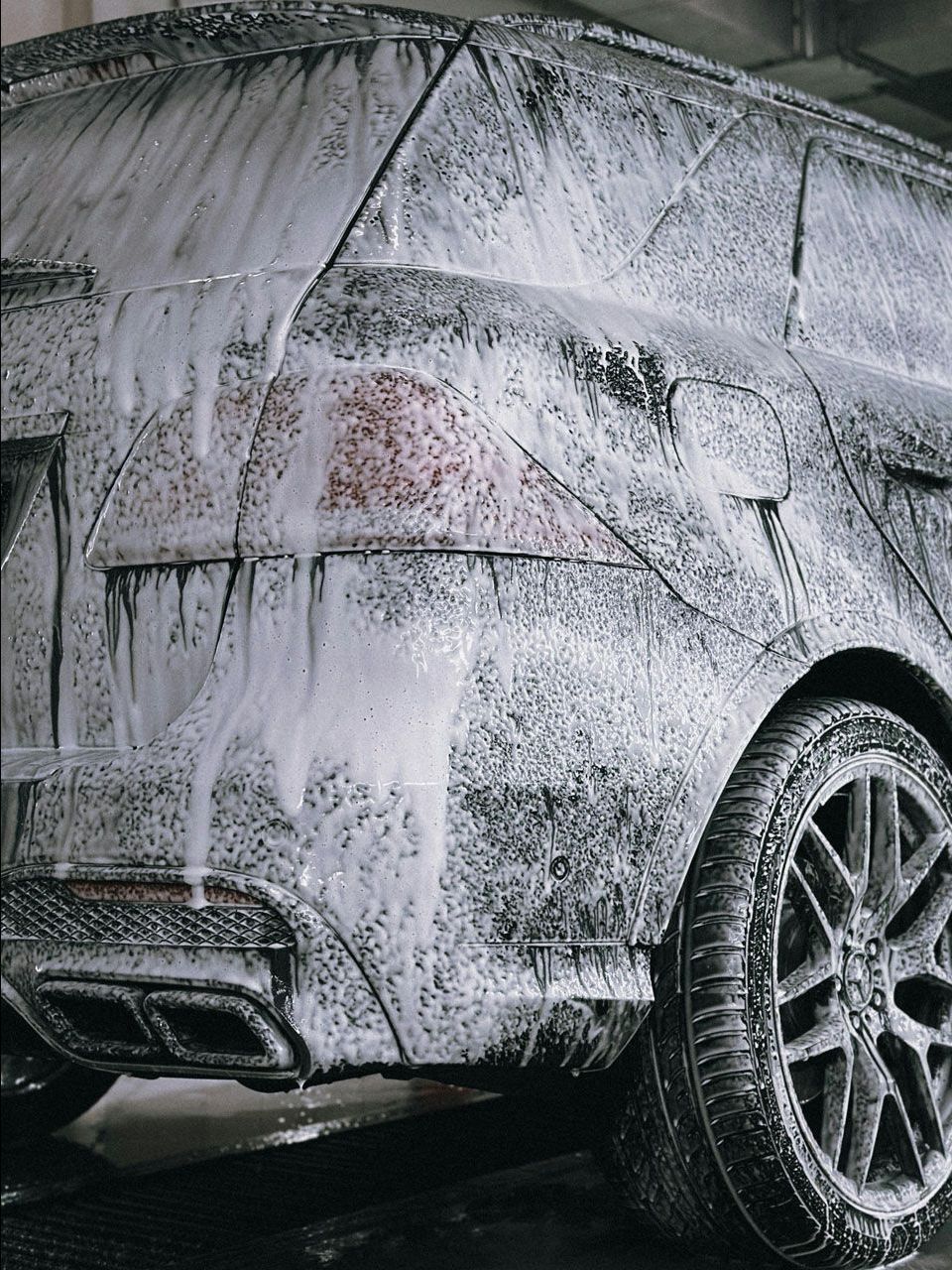 A close up of water drops on the hood of a car