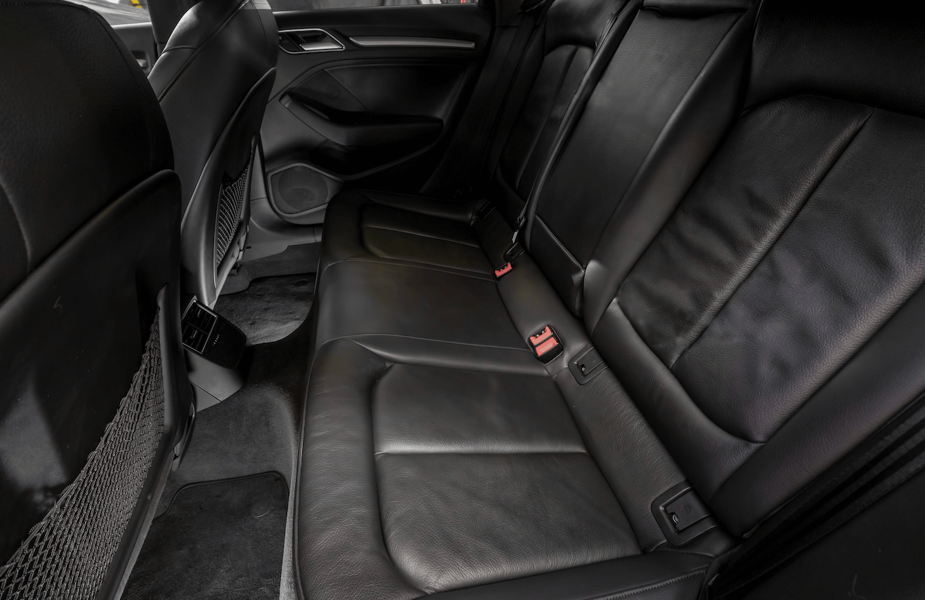 A close up of the back seat of a car.