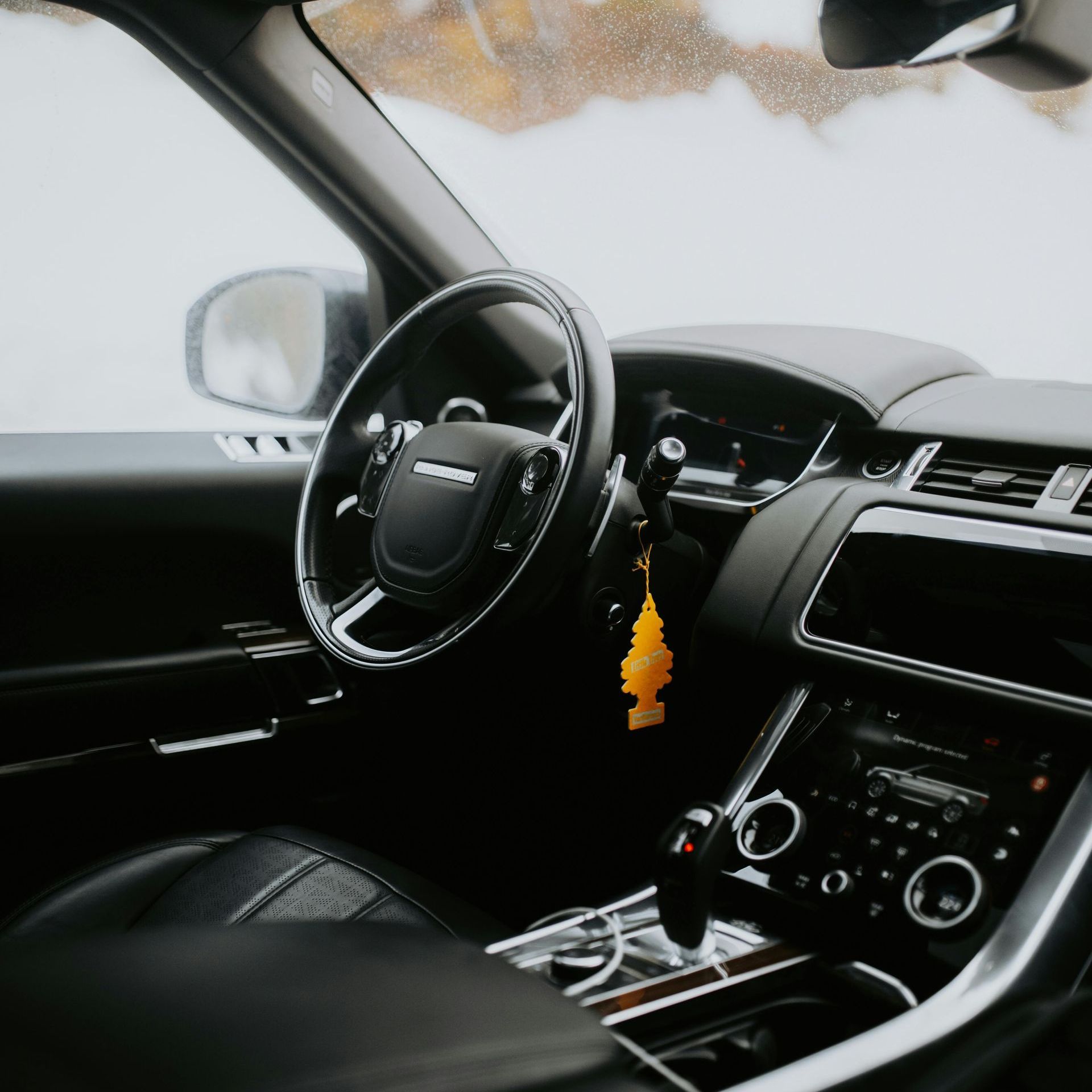 A yellow sports car is parked in a garage.