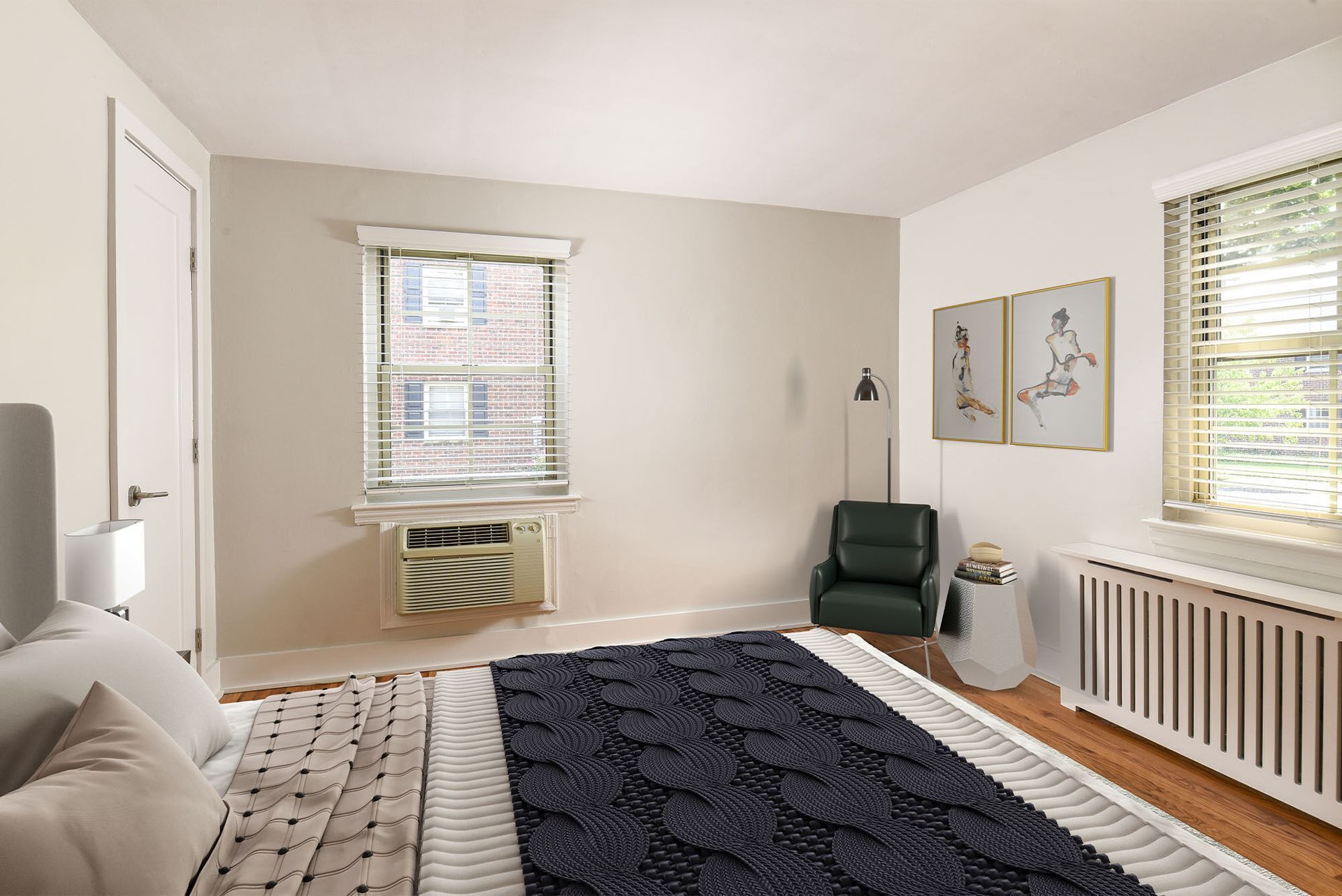Bedroom in an apartment with a bed, window blinds, and a window air conditioner.