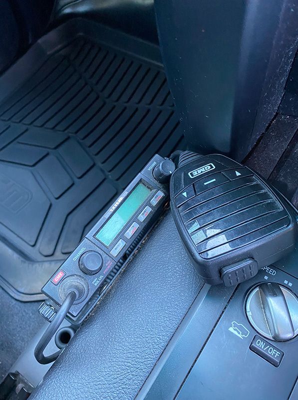 A Cb Radio Is Sitting On The Floor Of A Car — DPF Centre In Cessnock, NSW