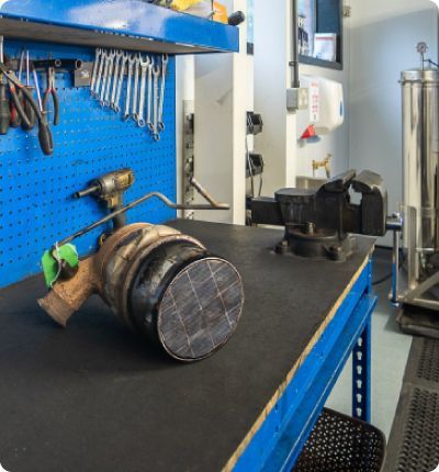 A Piece Of Metal Is Sitting On A Table In A Workshop — DPF Centre In Muswellbrook, NSW