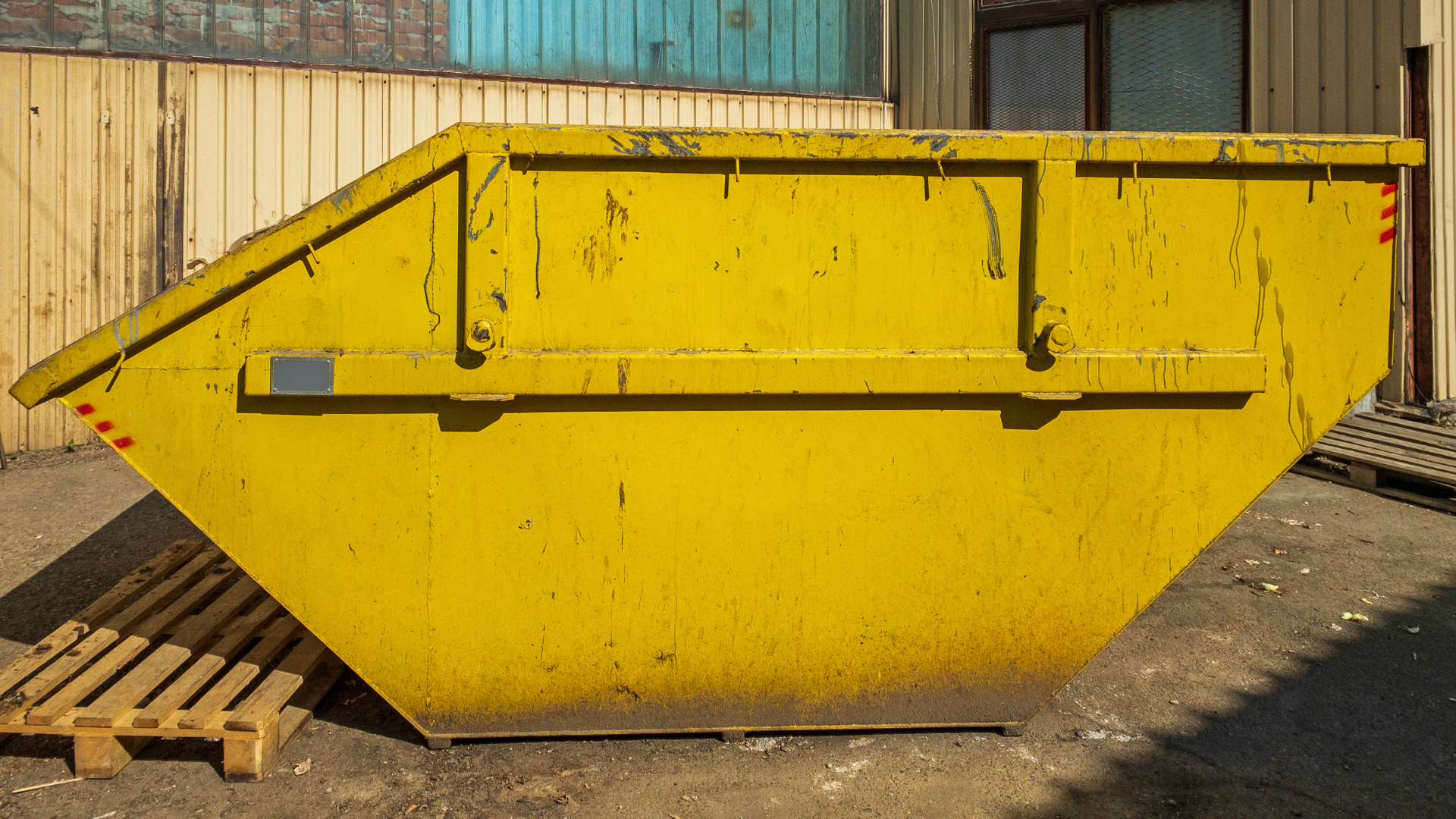 Homeowners using dumpster rental for garage cleanout and junk removal project