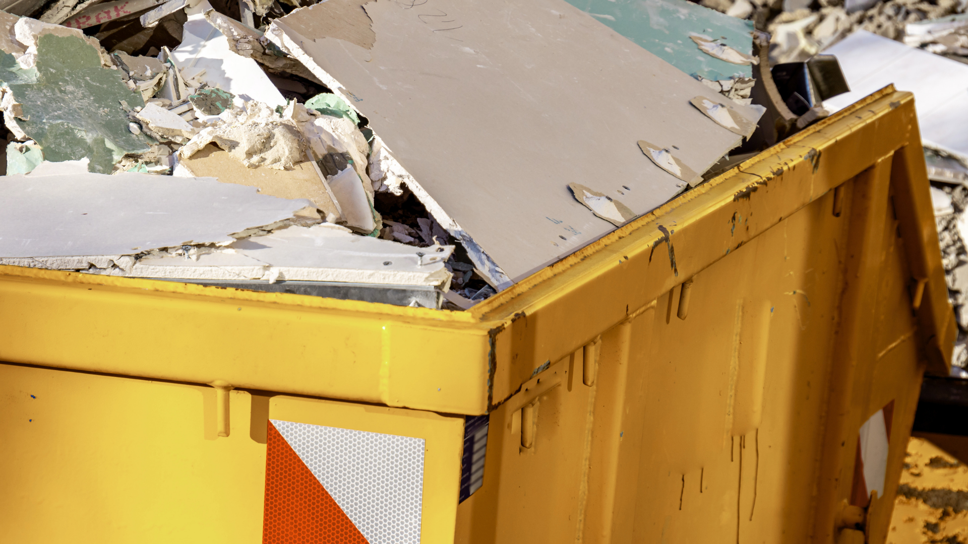 Dumpster rental truck delivering container for residential cleanup project
