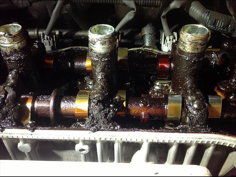 A Close Up of a Car Engine With a Lot of Oil on It — Hastings River Brake & Exhaust in Port Macquarie, NSW