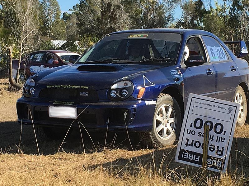 A Blue Car is Parked Next to a Sign — Hastings River Brake & Exhaust in Port Macquarie, NSW