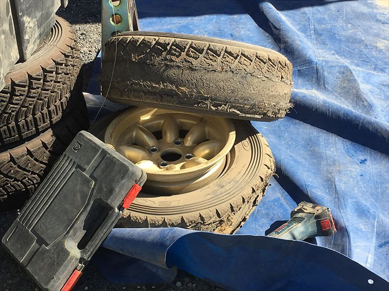 There are Tyres Laying on a Blue Tarp Next to a Toolbox — Hastings River Brake & Exhaust in Port Macquarie, NSW