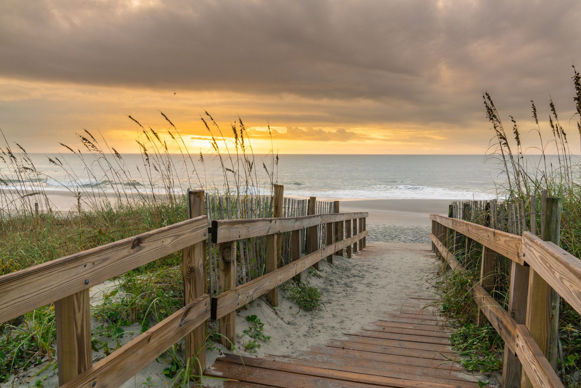 Coastal boardwalk leading to Grand Strand South Carolina beach showing HVAC system climate impact.