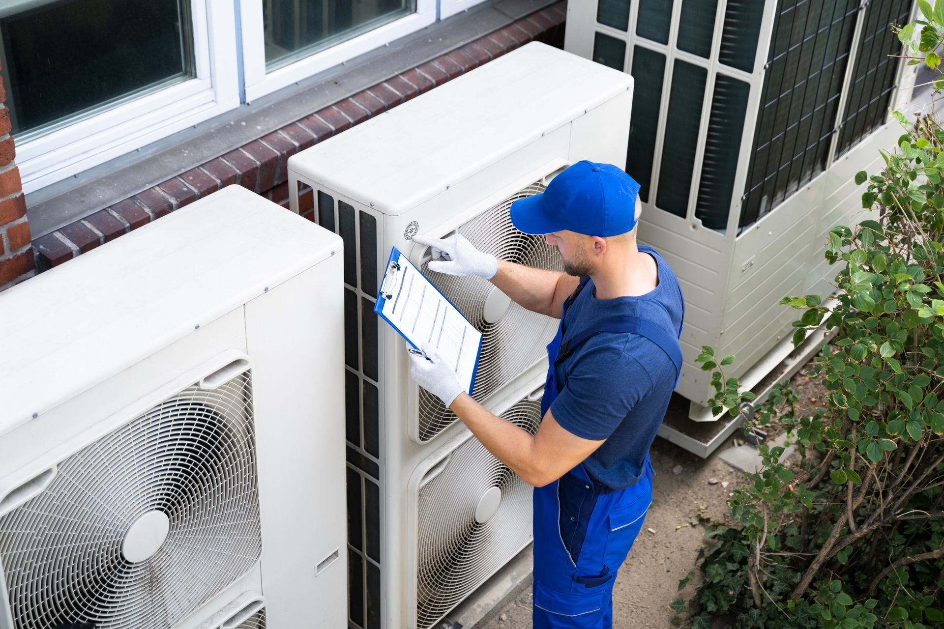 Ocean Air Cooling technician checking air conditioning unit.