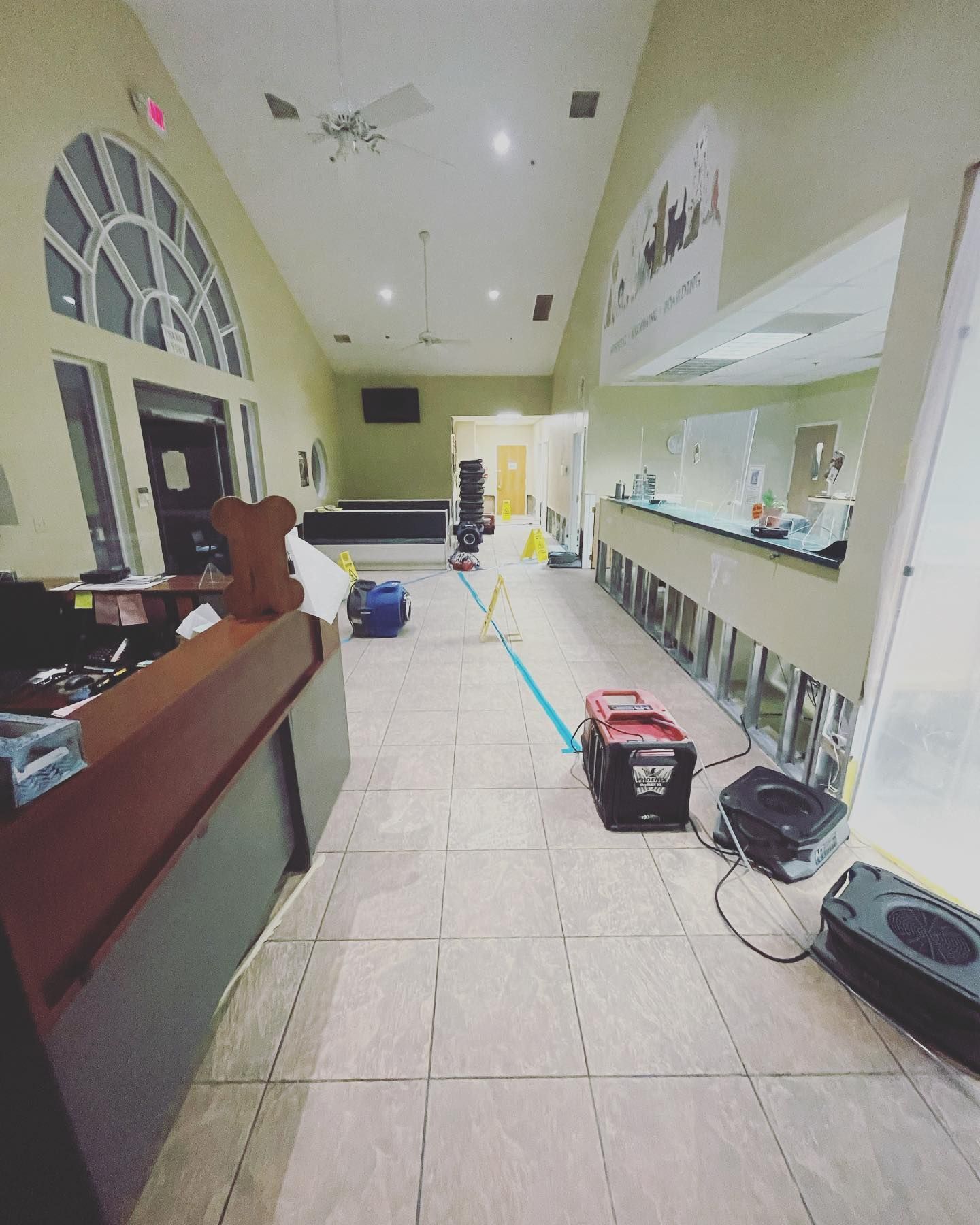 Interior with damaged walls and equipment, possible flood damage.