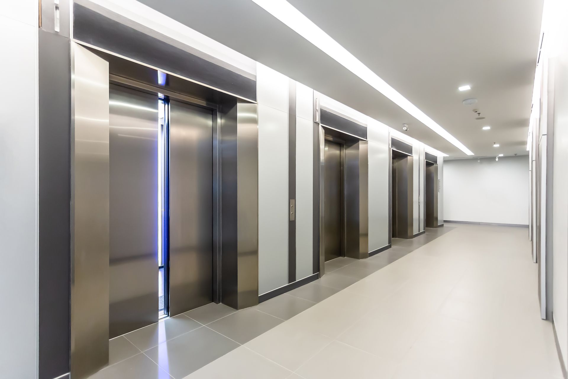 Hallway with four silver elevators