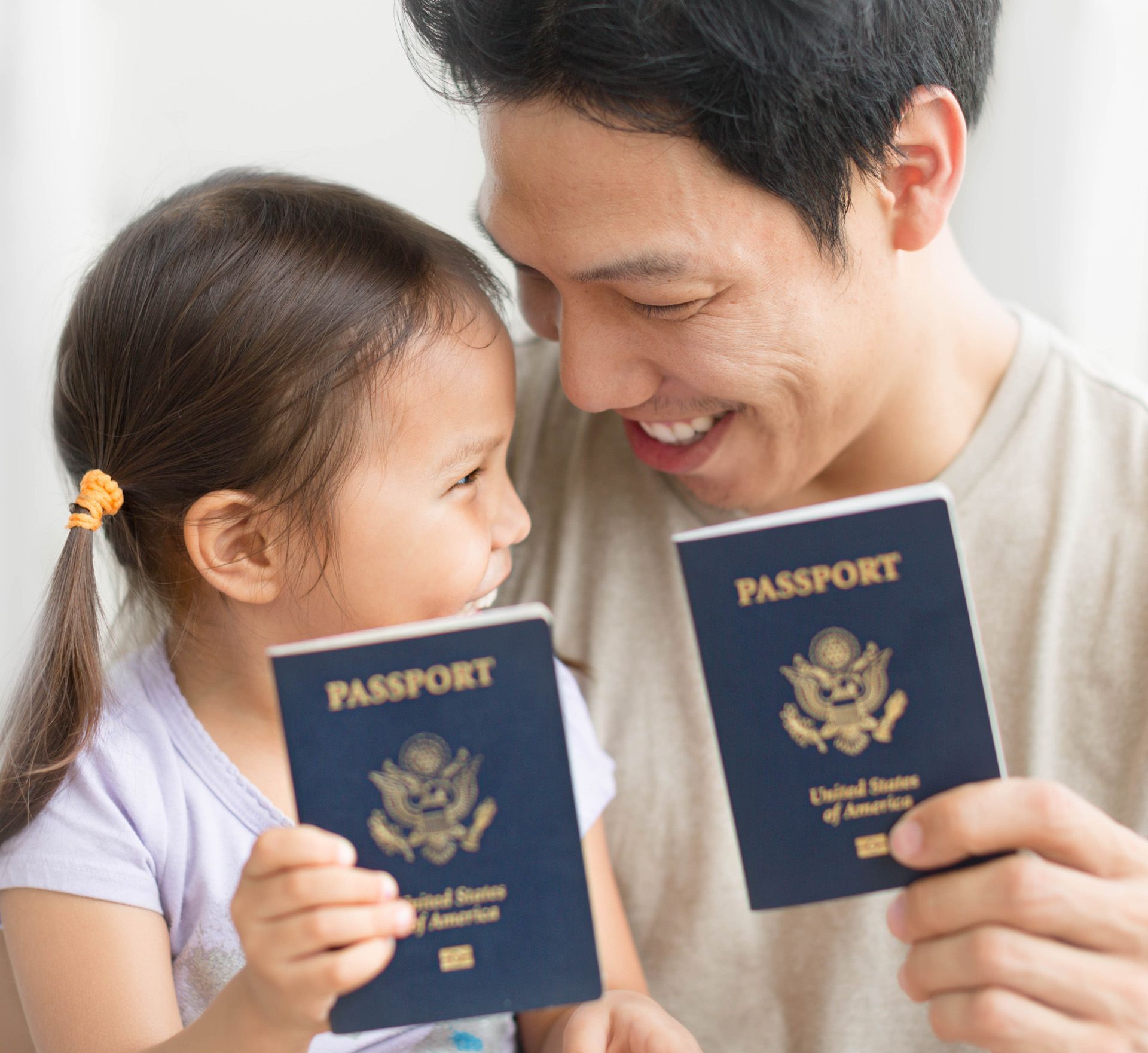 A man and a little girl are holding passports