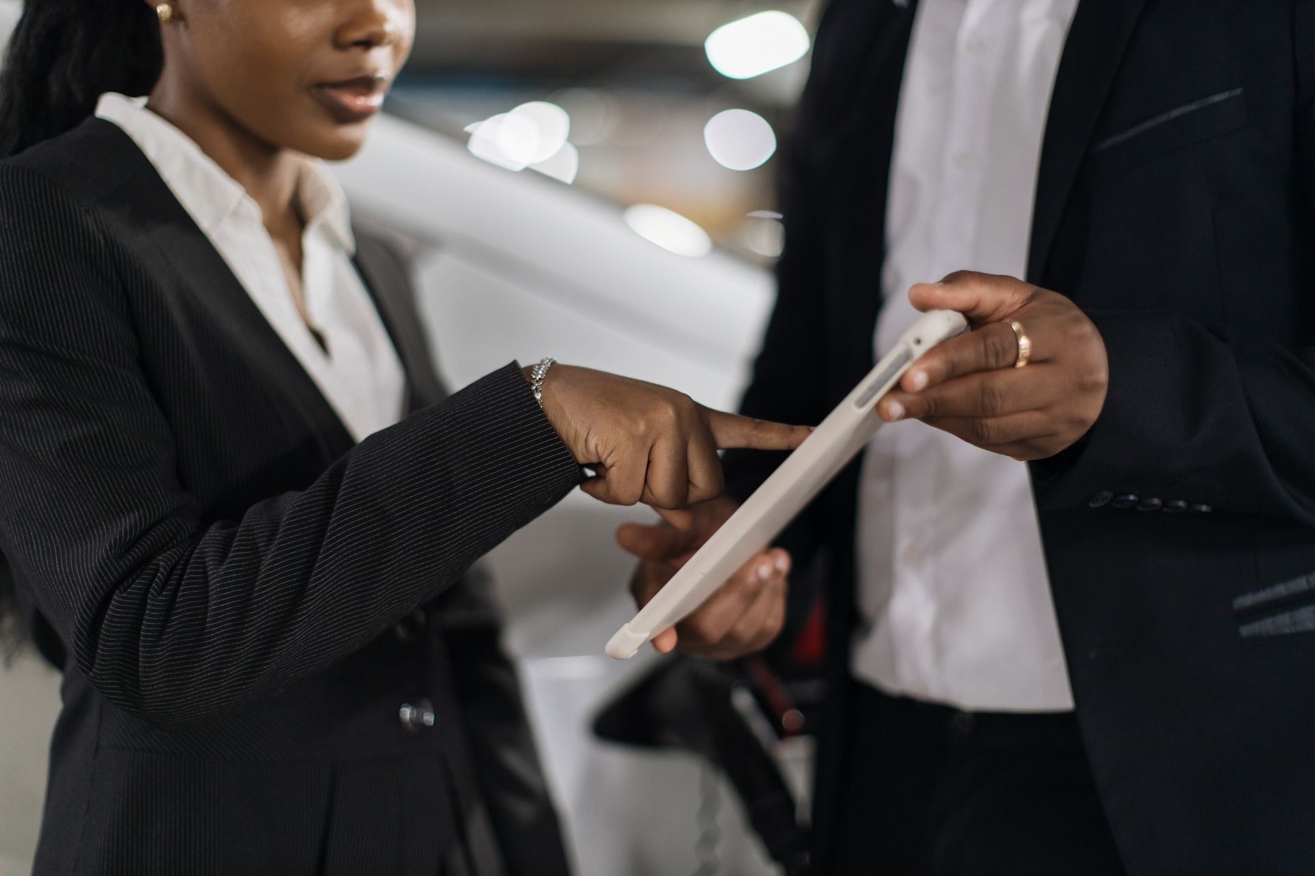 A man and a woman are looking at a tablet together.