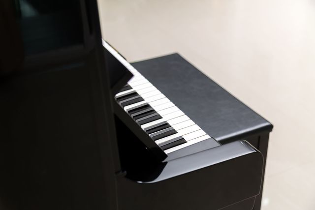 A close up of a black piano with white keys