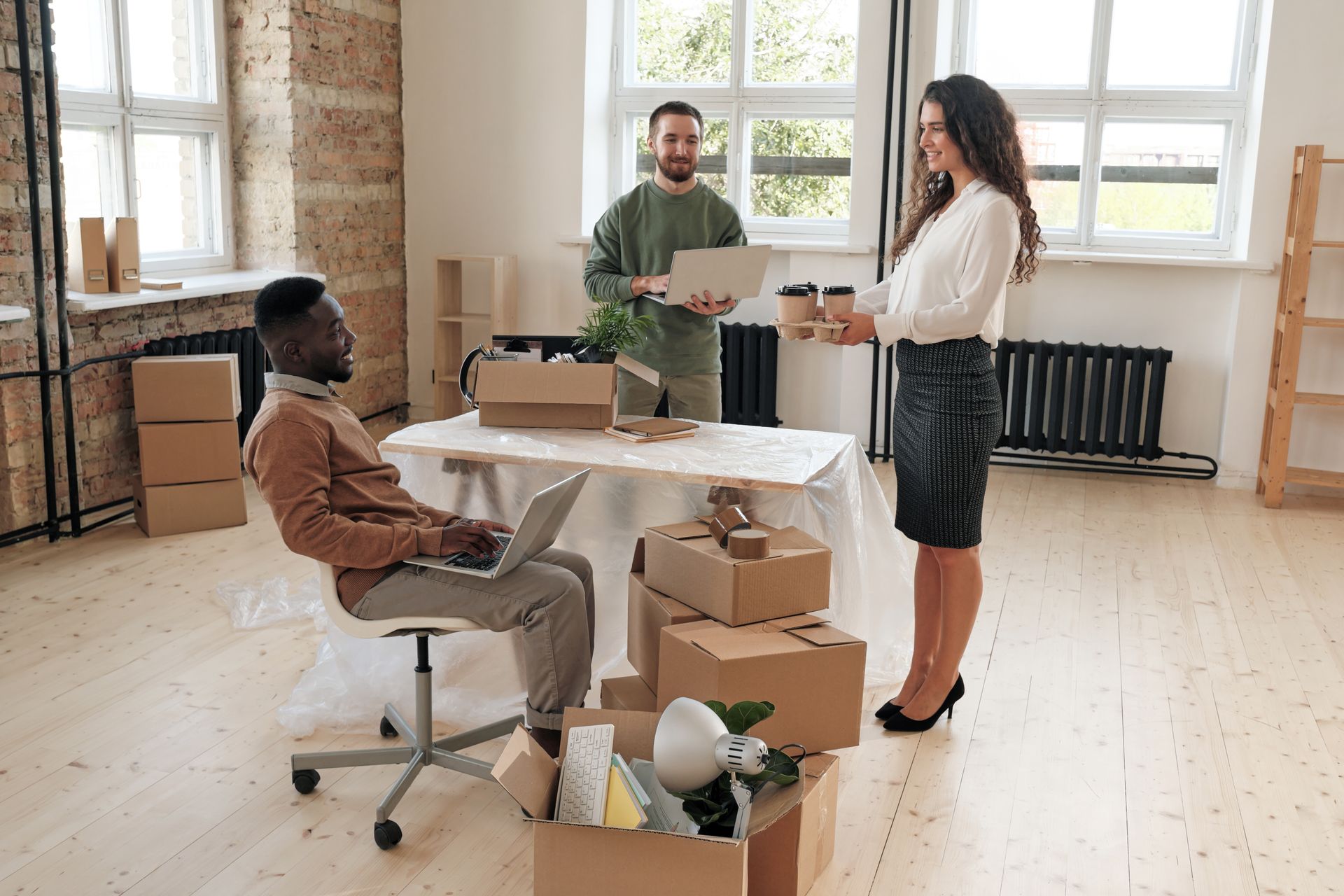 A group of people are moving into a new office.