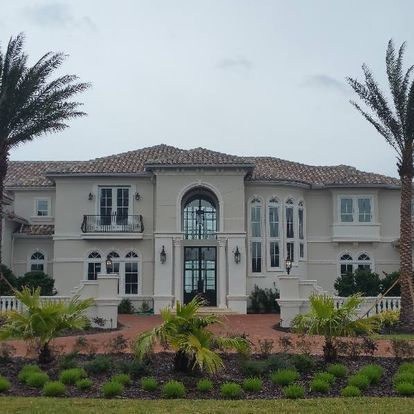 A large house with palm trees in front of it