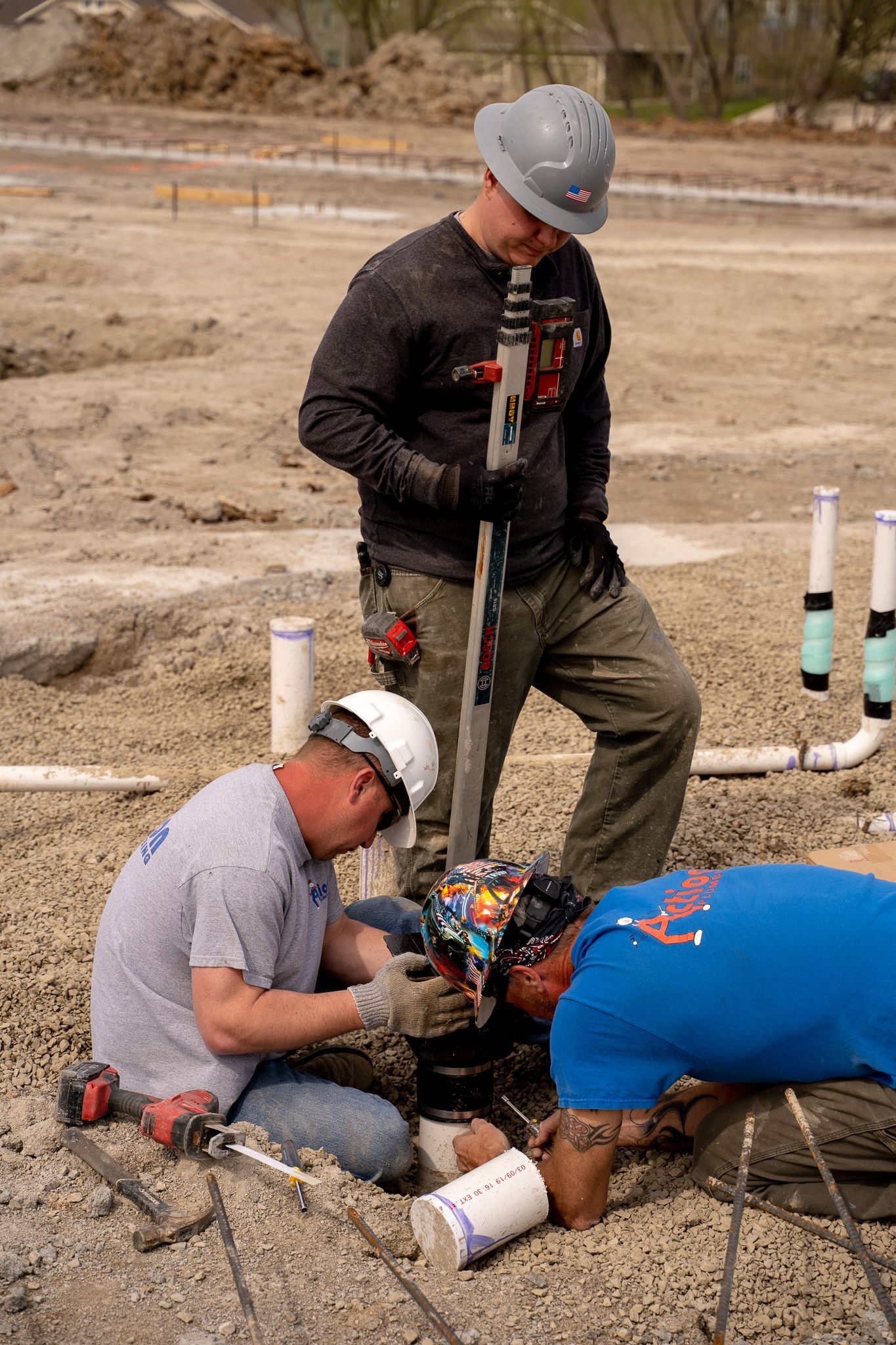 a group ofplumbing workers are working on a construction site .