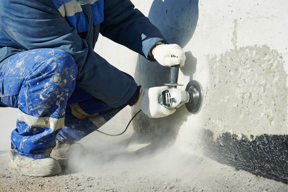 Man Working Using Grinder — Ultra Services Ground Pavement & Building Pty Ltd in Abercrombie, NSW