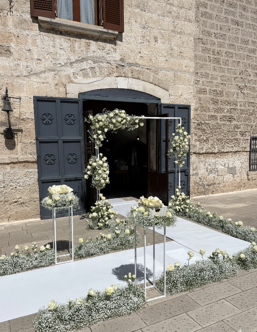 Ingresso della chiesa decorato con fiori bianchi per un matrimonio.