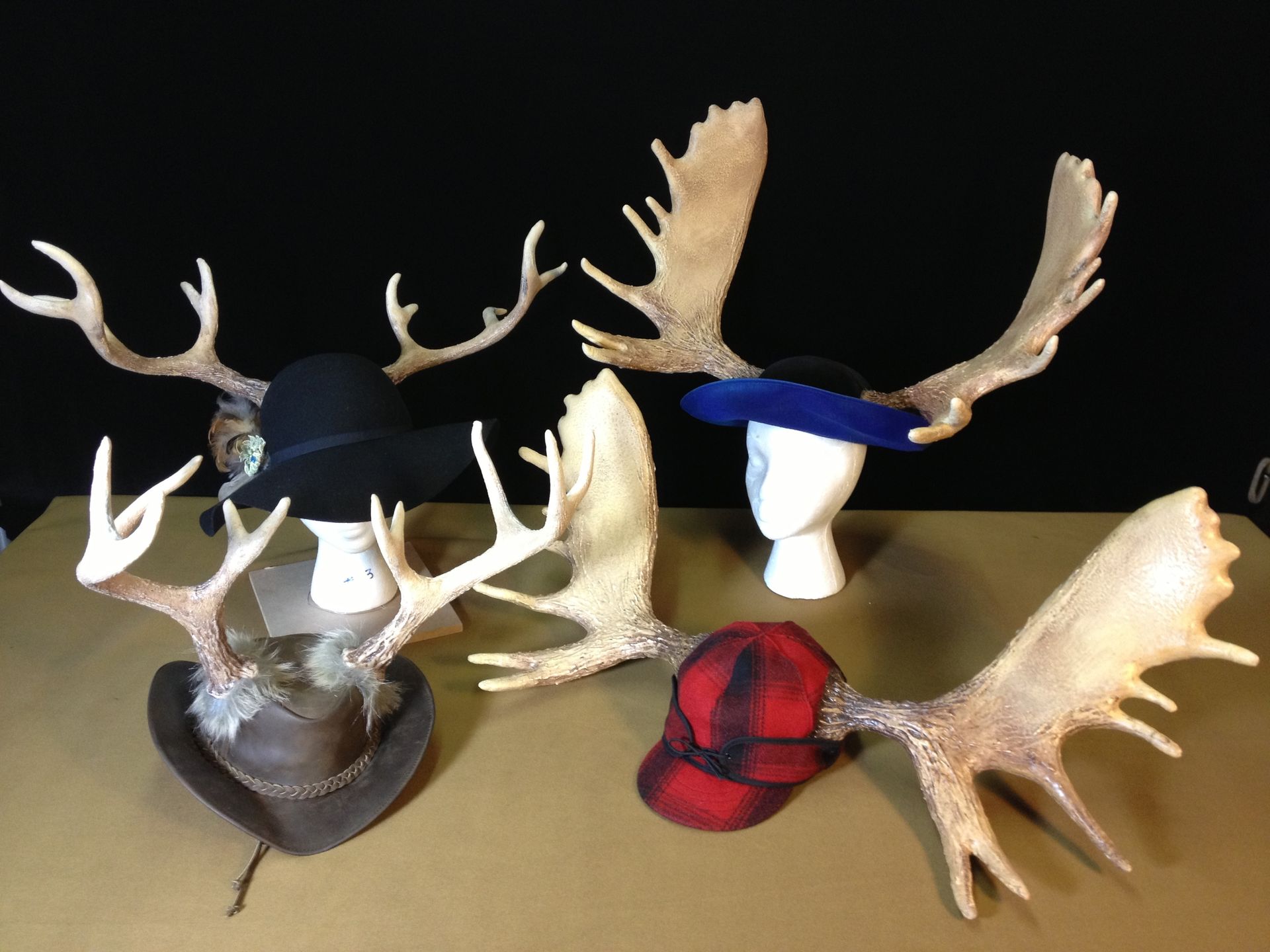 A group of hats and antlers on a table