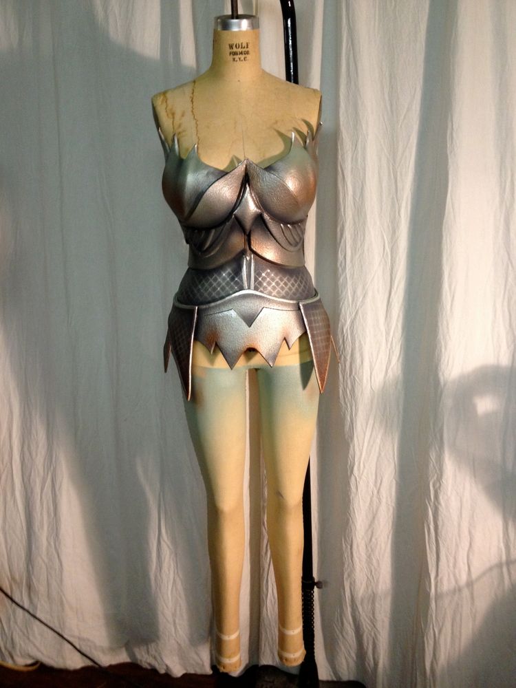 A mannequin is wearing a silver armored outfit