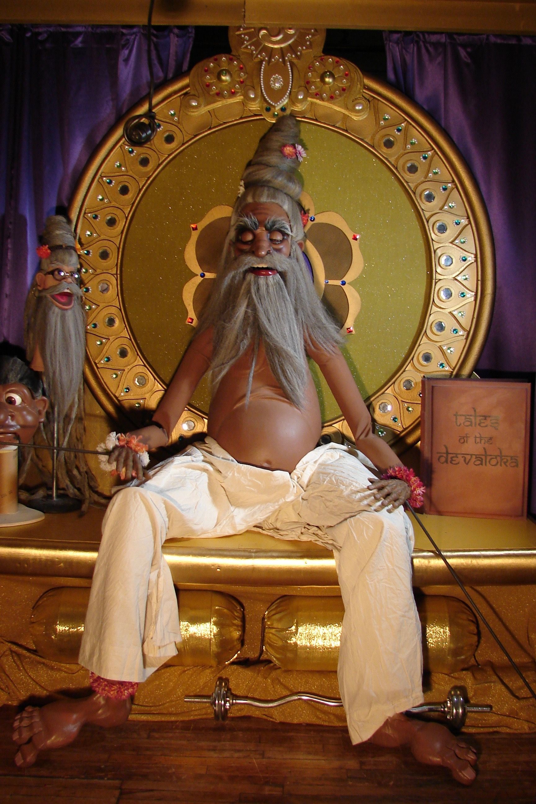 A statue of a man with a beard is sitting on a throne.