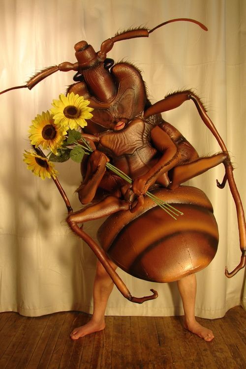 cockroach costume holding sunflowers
