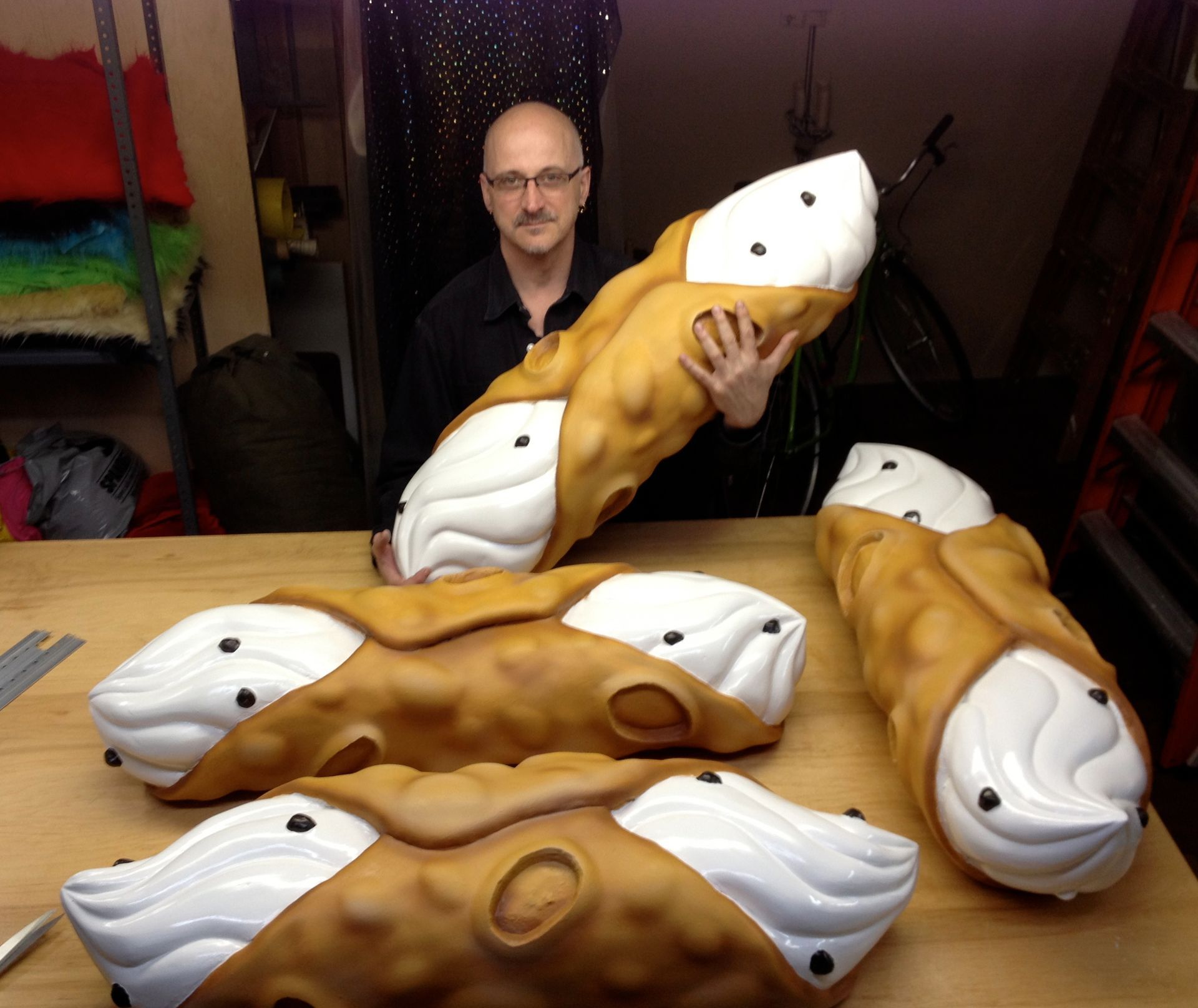 A man is holding a large cone with whipped cream on it