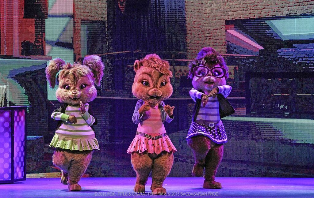 Three alvin and the chipmunks are dancing on a stage.